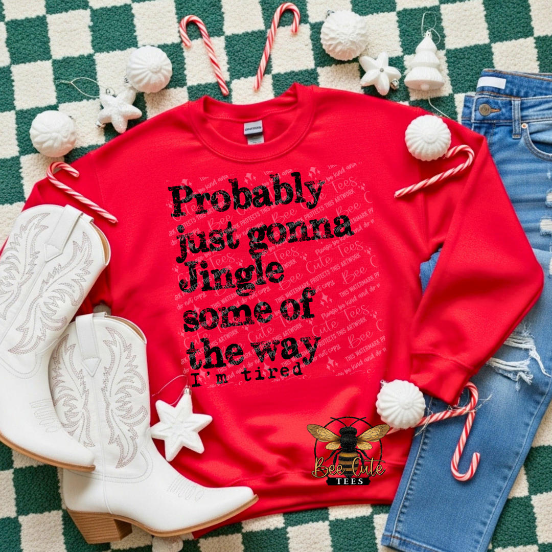 Red sweatshirt with text, white cowboy boots, and Christmas decorations on a checkered floor.