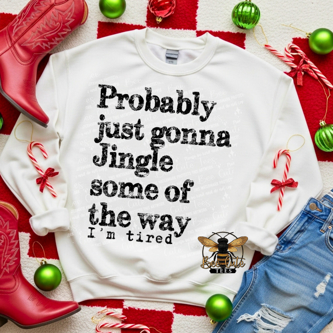 White sweatshirt with Christmas-themed text on a festive background with red boots, green ornaments, and candy canes.