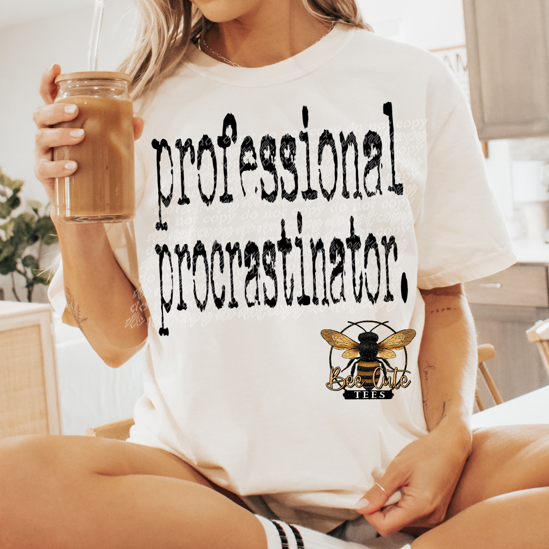 Person wearing a white t-shirt with 'professional procrastinator' text and a bee logo, holding a drink.
