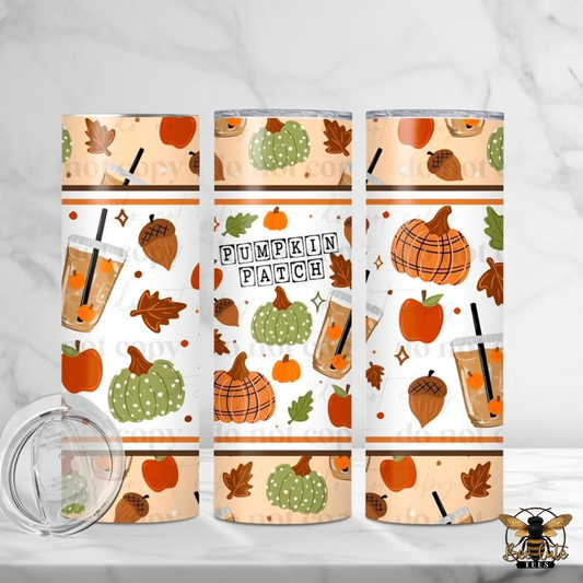 Three insulated tumblers with a fall 'Pumpkin Patch' pattern are displayed on a white marble background, alongside a clear lid. The pattern features orange pumpkins, green spotted pumpkins, acorns, leaves, and iced coffee cups on a warm beige background.