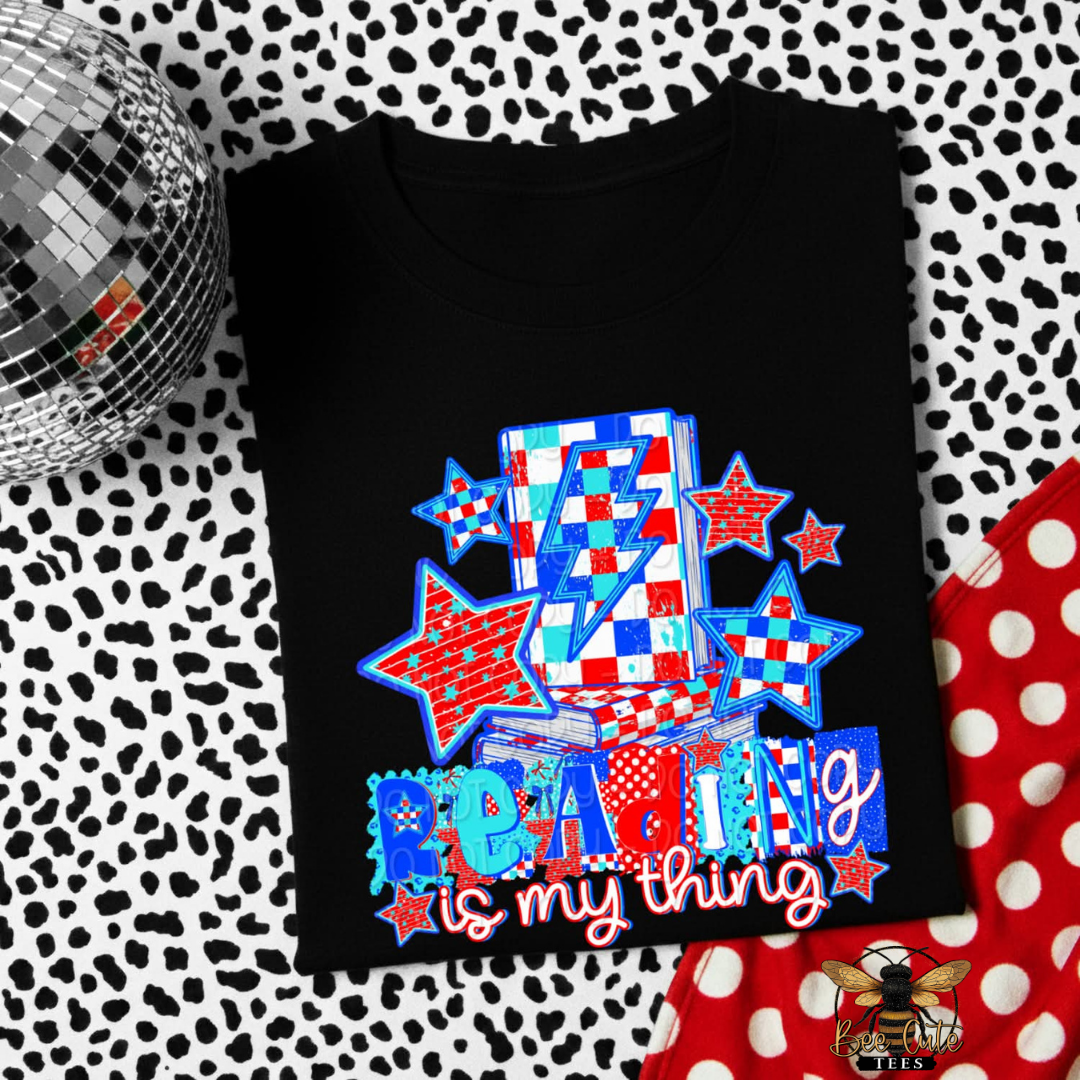 Black t-shirt with colorful design and text on a patterned background