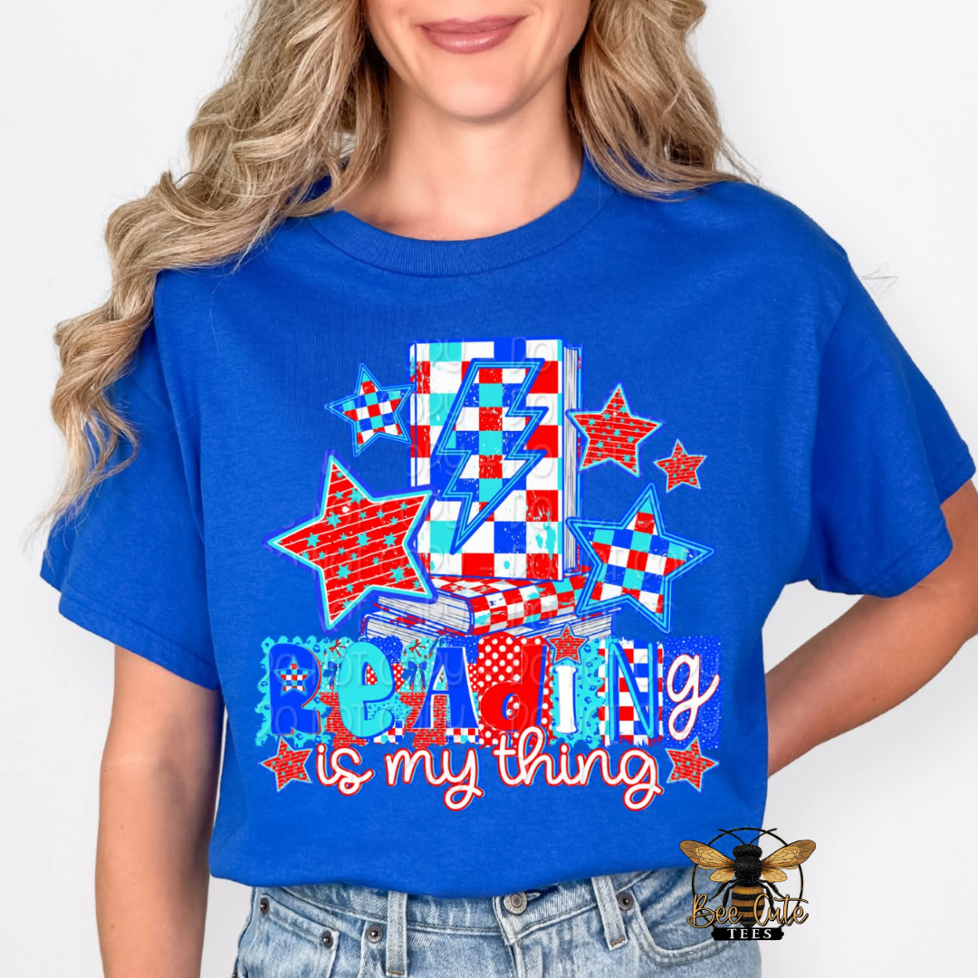 Person wearing a blue t-shirt with colorful design and text on a white background