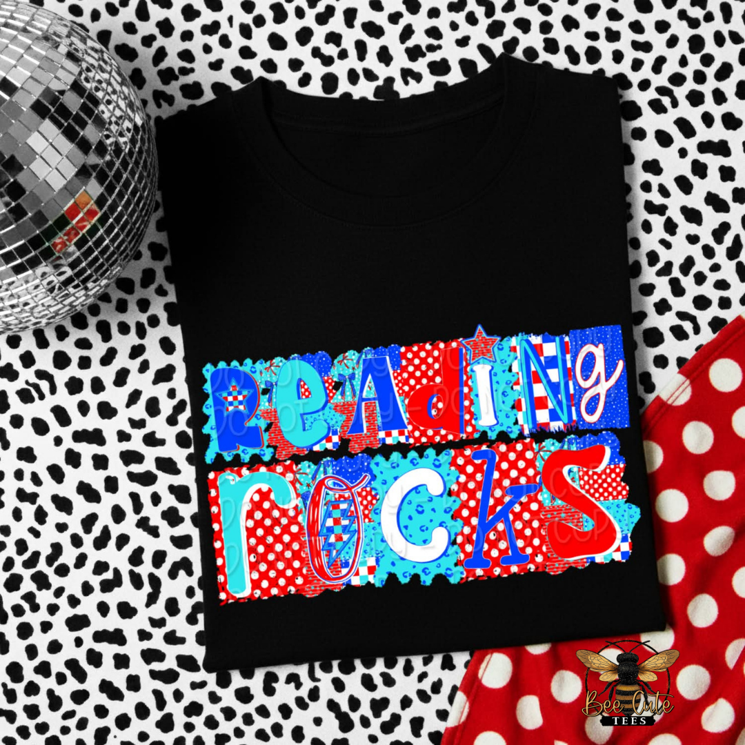 Black t-shirt with 'Reading Rocks' text in colorful letters on a patterned background