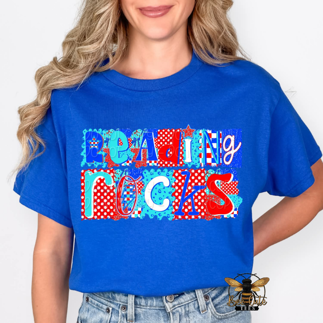 Person wearing a blue t-shirt with 'reading Rocks' design on a plain background