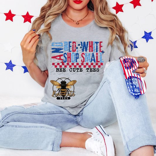 Person wearing a gray sweatshirt with a bee design and text, sitting on a white surface with red and blue star decorations.