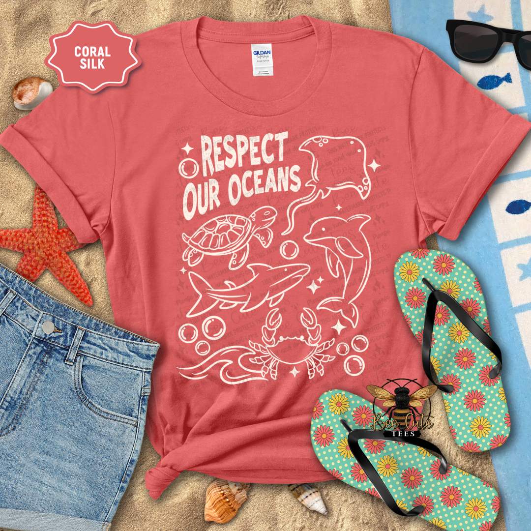 Red t-shirt with 'Respect Our Oceans' design on a beach-themed background