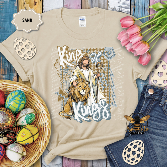 Beige t-shirt with religious design featuring Jesus, a lion, and text, surrounded by Easter decorations.
