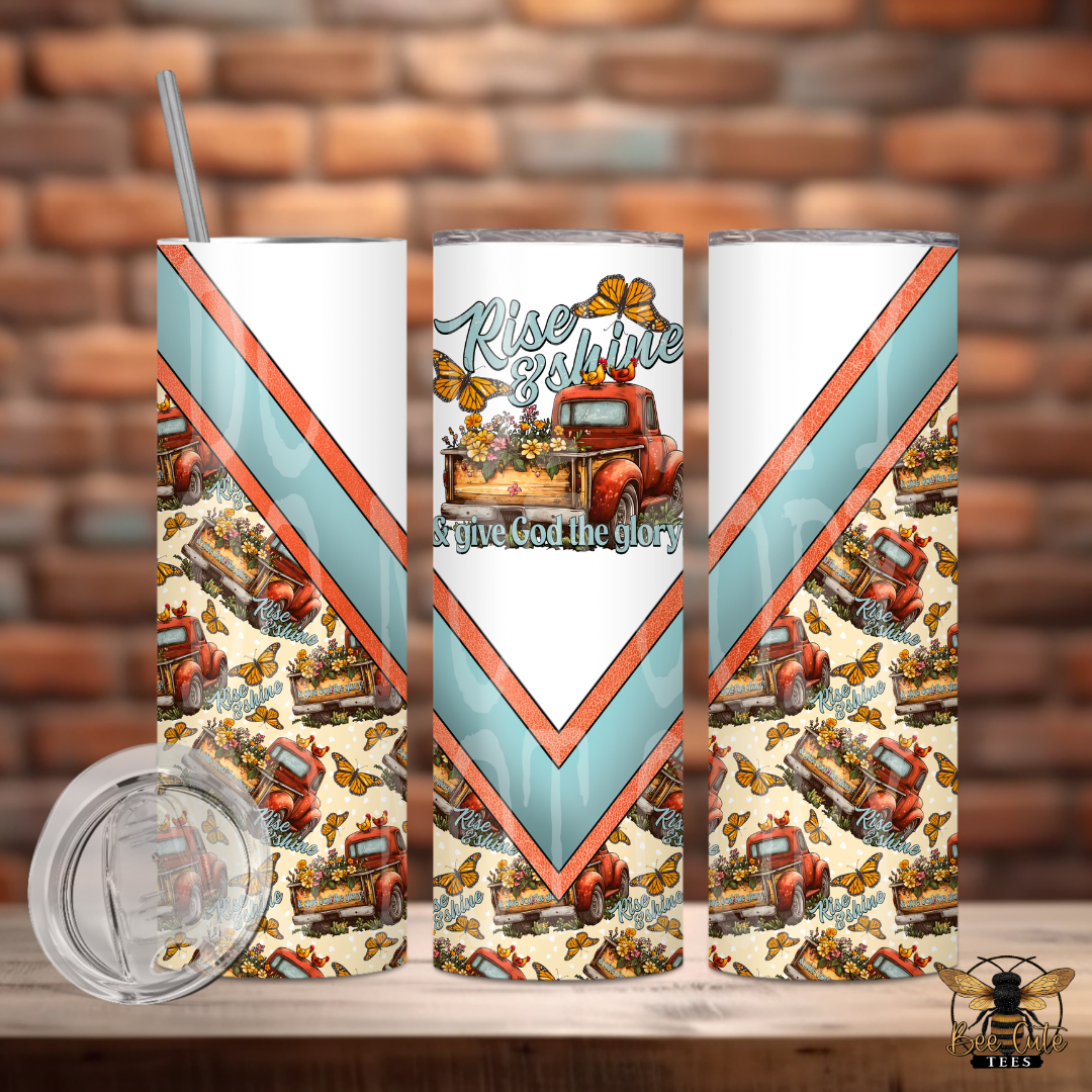 Tumbler with vintage truck design and text on a wooden surface with brick wall background