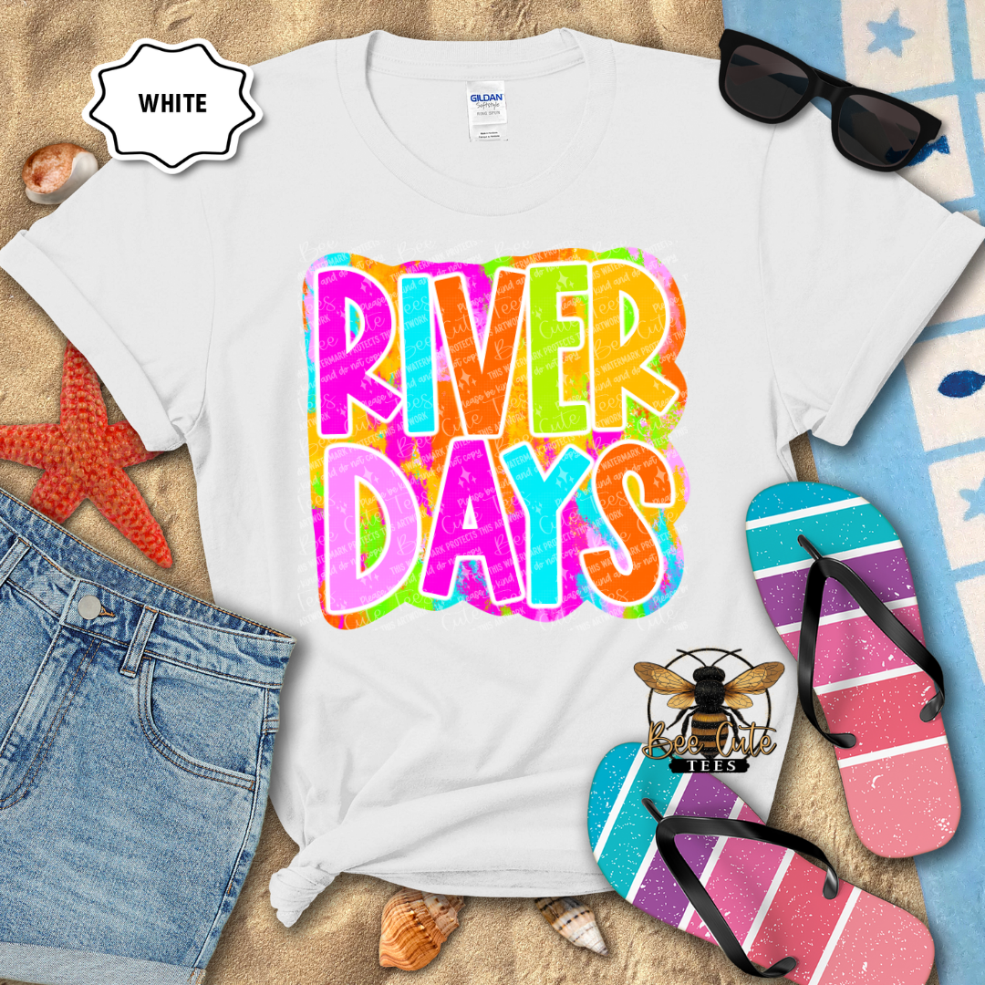 White t-shirt with 'River Days' design, sunglasses, and flip-flops on a beach-themed background.