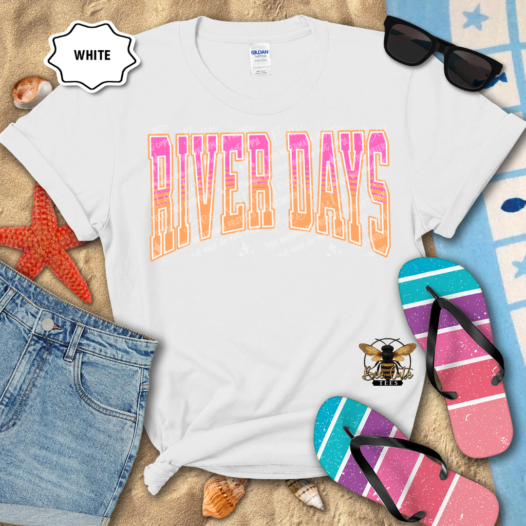 White t-shirt with 'RIVER DAYS' text, sunglasses, denim shorts, and flip-flops on a sandy background