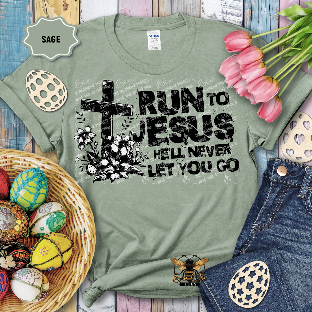 Green t-shirt with 'Run to Jesus, hell never let you go' design on a wooden surface with Easter decorations.