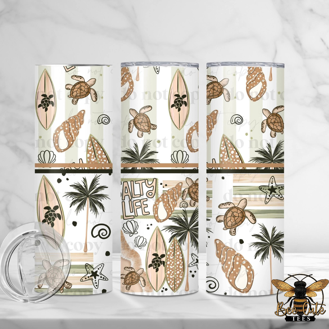 Three tumblers with beach-themed designs featuring turtles, palm trees, and surfboards on a white background.