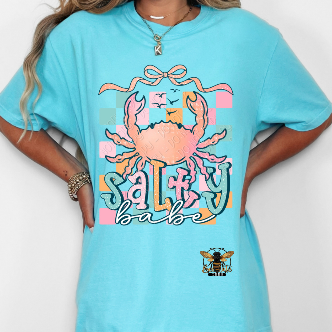 Person wearing a blue t-shirt with a colorful crab graphic and text on a white background
