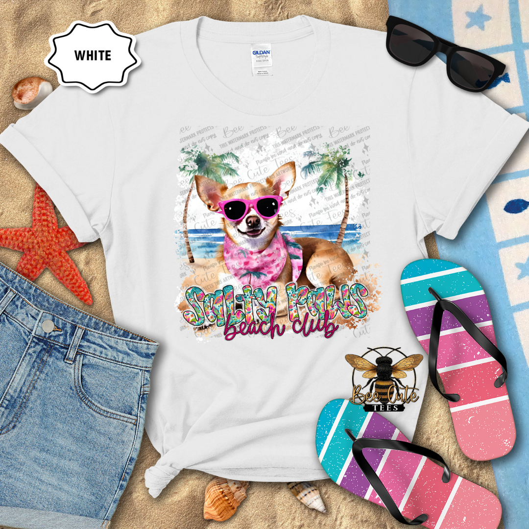 White t-shirt with a dog graphic and text on a beach-themed background
