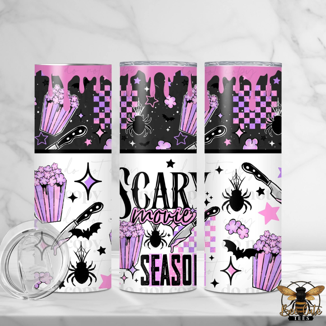 Three tall skinny tumblers with a pink and black Halloween-themed design, including silhouettes of a haunted house, stars, bats, and popcorn. The bottom wraps feature the text 'SCARY movies SEASON!'.