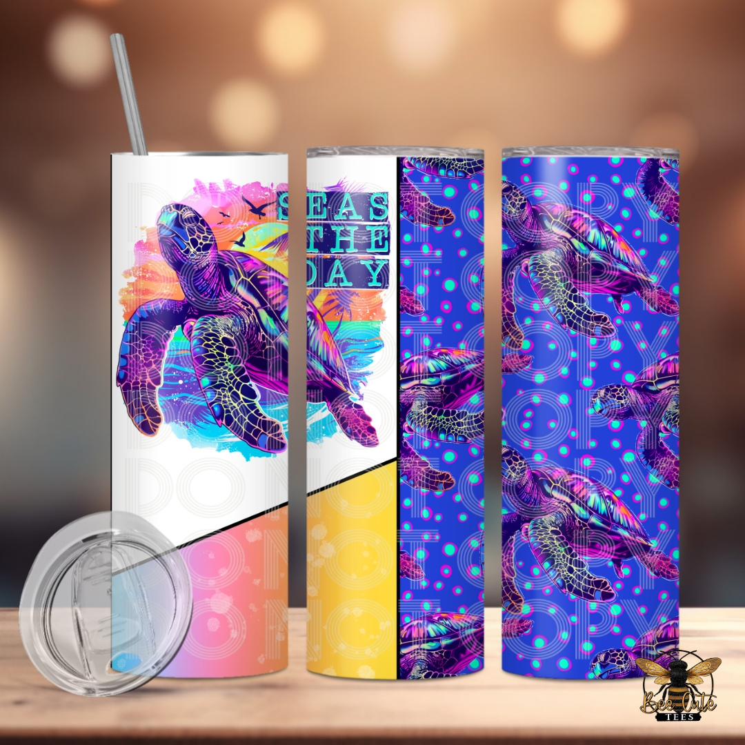 Bright and colorful 20 oz tumbler featuring a vibrant neon-style sea turtle design with tropical sunset accents and “Seas the Day” wording, paired with a coordinating purple sea turtle pattern wrap, displayed with a lid and metal straw against a softly lit background.
