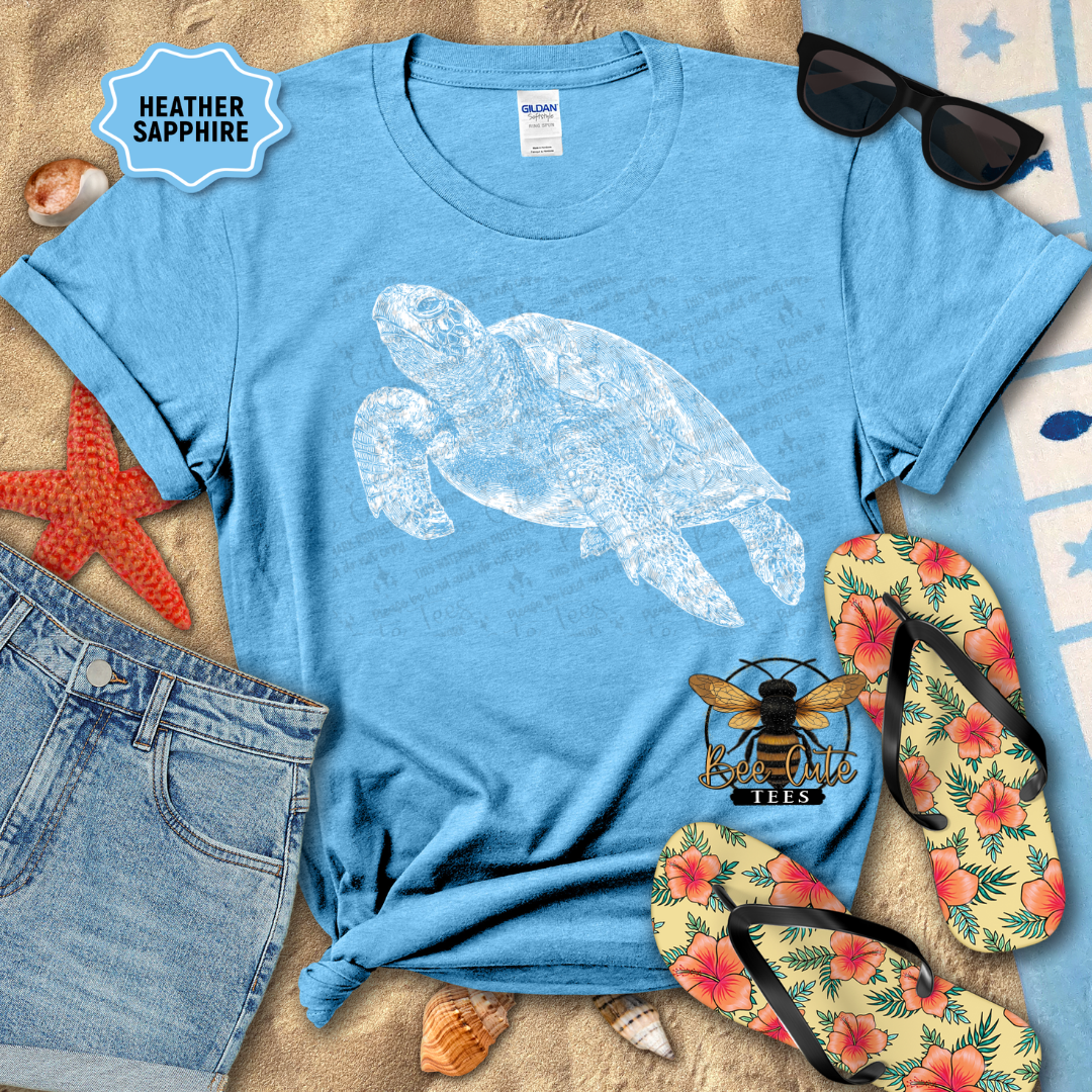 Blue t-shirt with turtle design, sunglasses, flip-flops, and denim shorts on a sandy background.