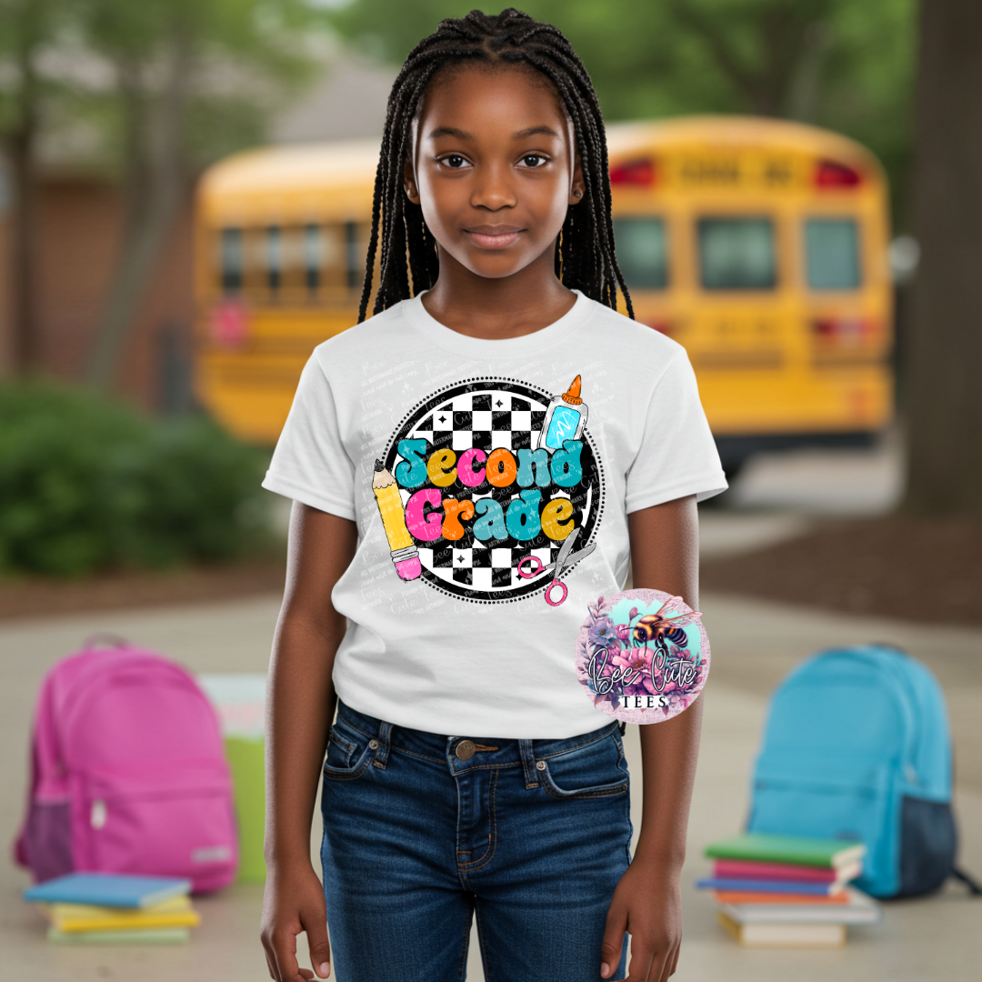 Young girl wearing a 'Second Grade' t-shirt with a school bus in the background
