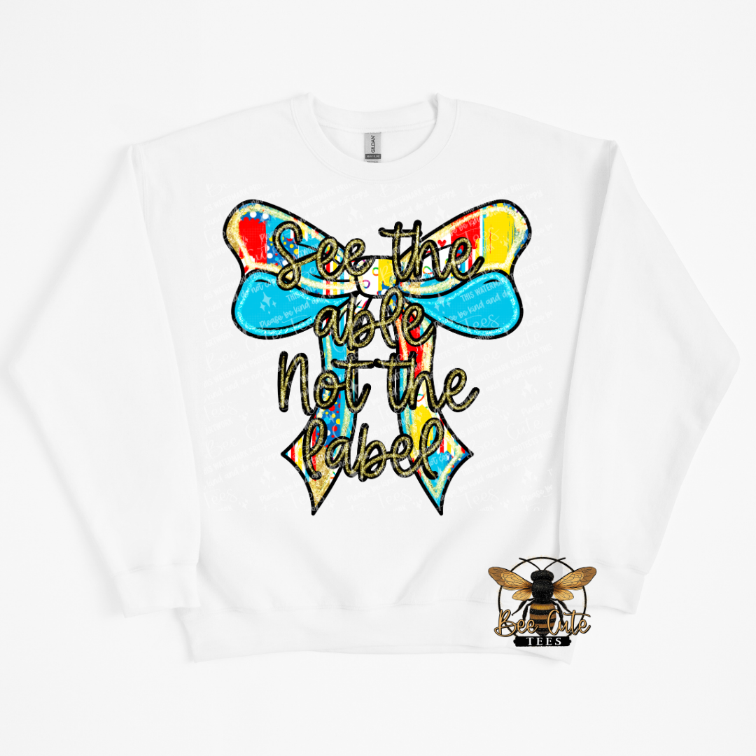 White sweatshirt with a colorful bow design and text on a white background