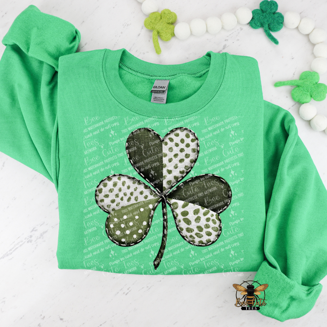 Green sweatshirt with a four-leaf clover design on a white background