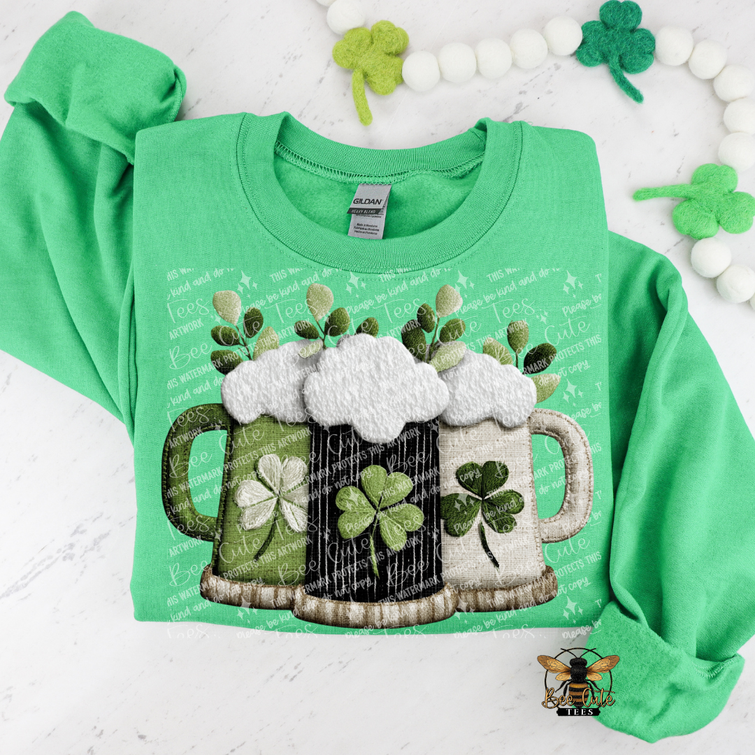 Green sweatshirt with beer mugs and shamrocks on a white background
