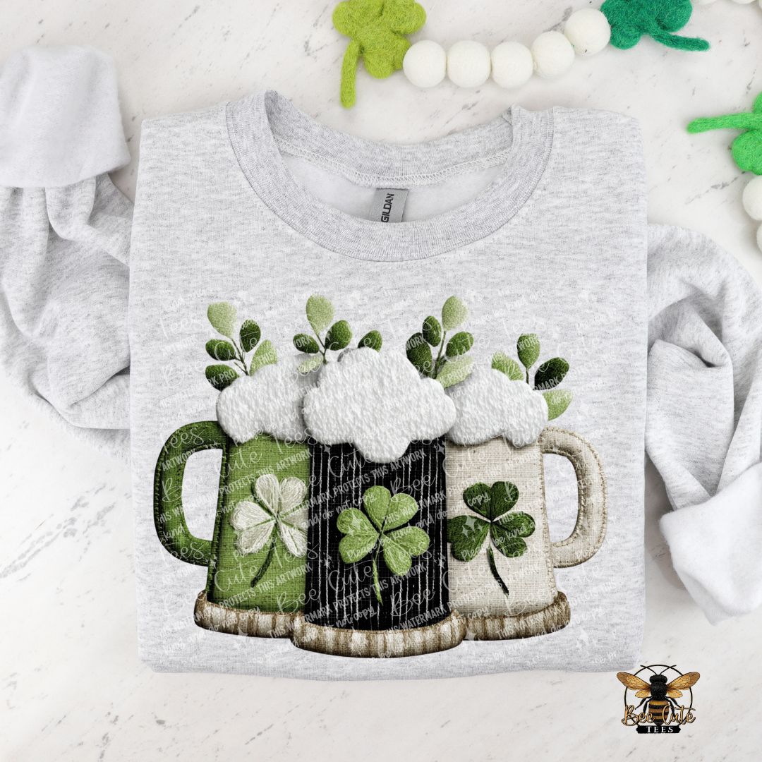 Gray t-shirt with beer mugs and shamrocks design on a white background