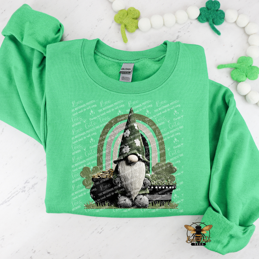 Green sweatshirt with a gnome and rainbow design on a white background with shamrocks.