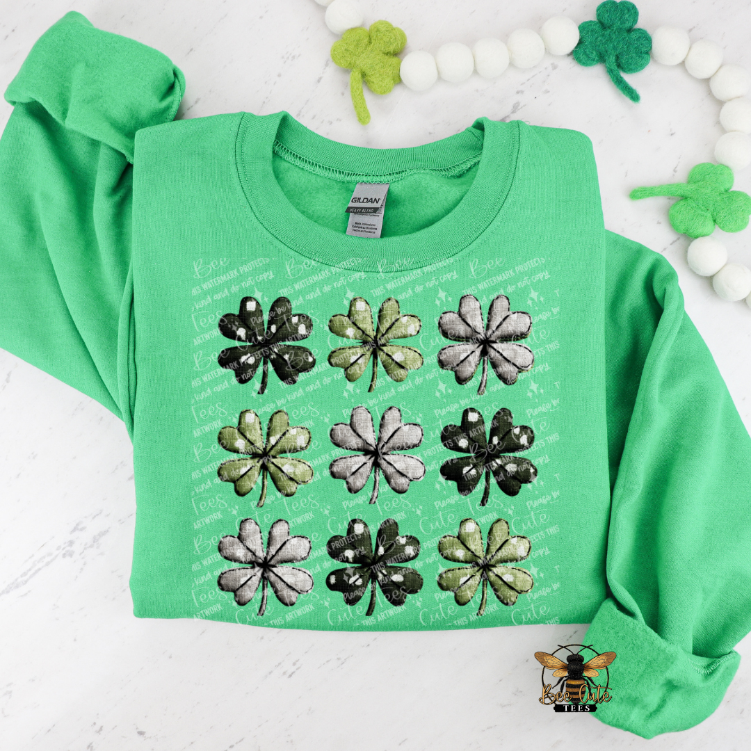 Green sweatshirt with shamrock designs on a white background