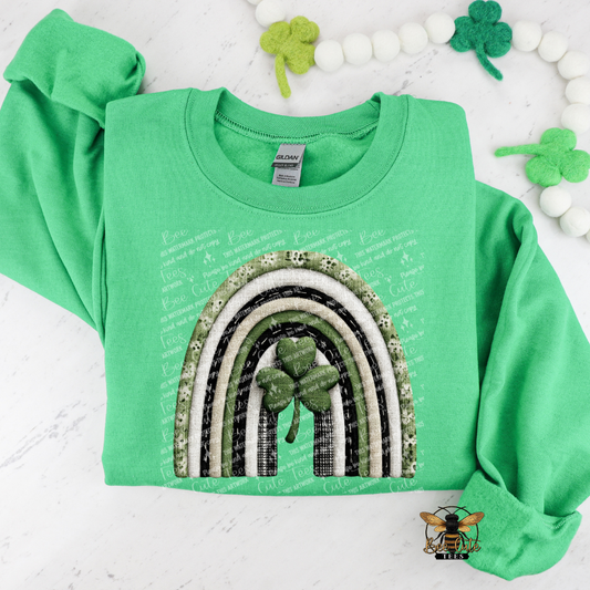 Green sweatshirt with rainbow and shamrock design on a white background