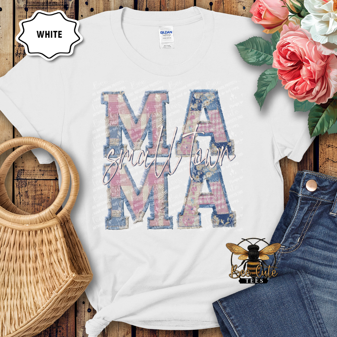 White t-shirt with 'MAMA' print on a wooden surface with flowers and denim jeans.