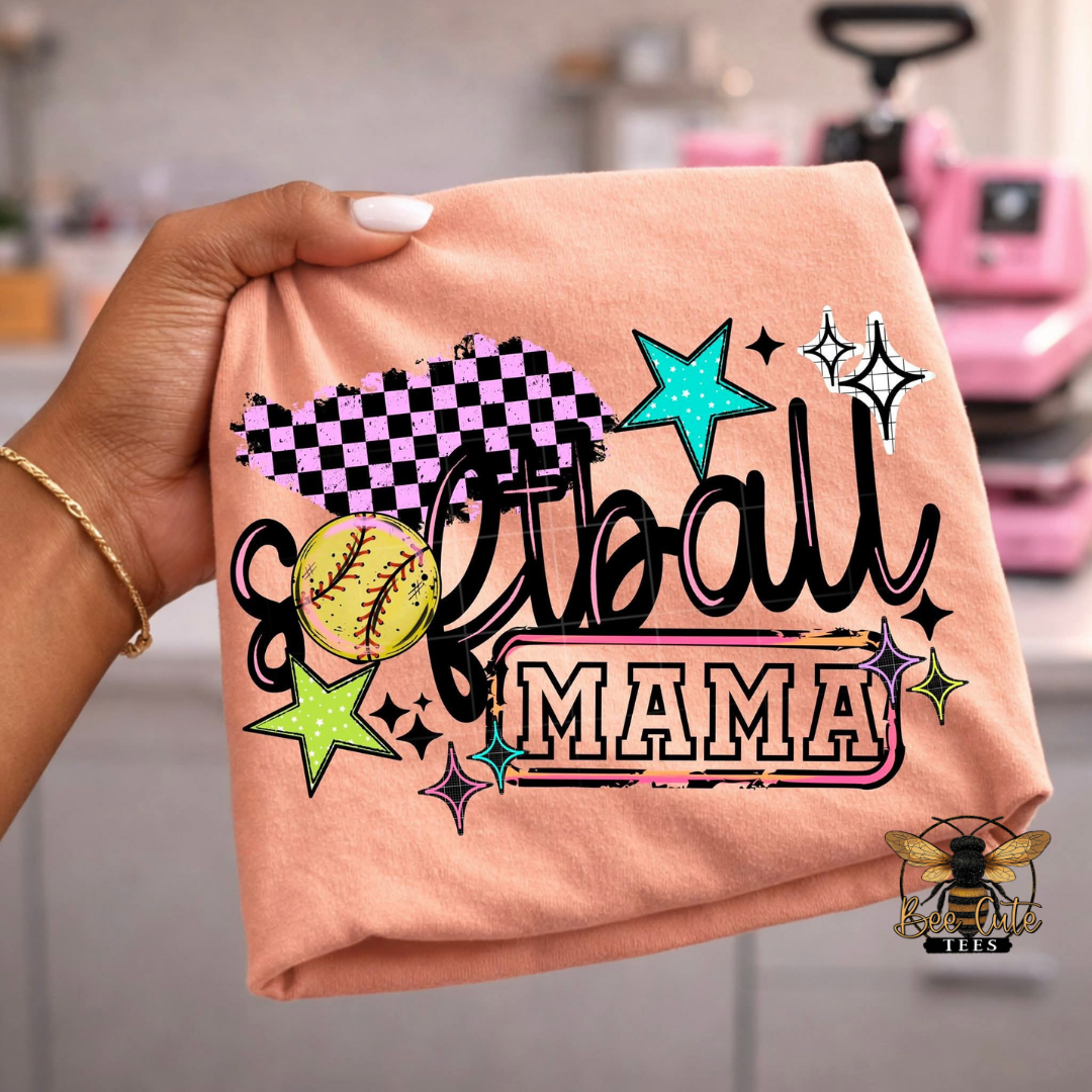 Orange t-shirt with 'Softball Mama' text and graphics held by a hand.