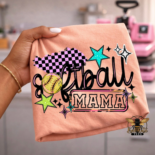 Orange t-shirt with 'Softball Mama' text and graphics held by a hand.