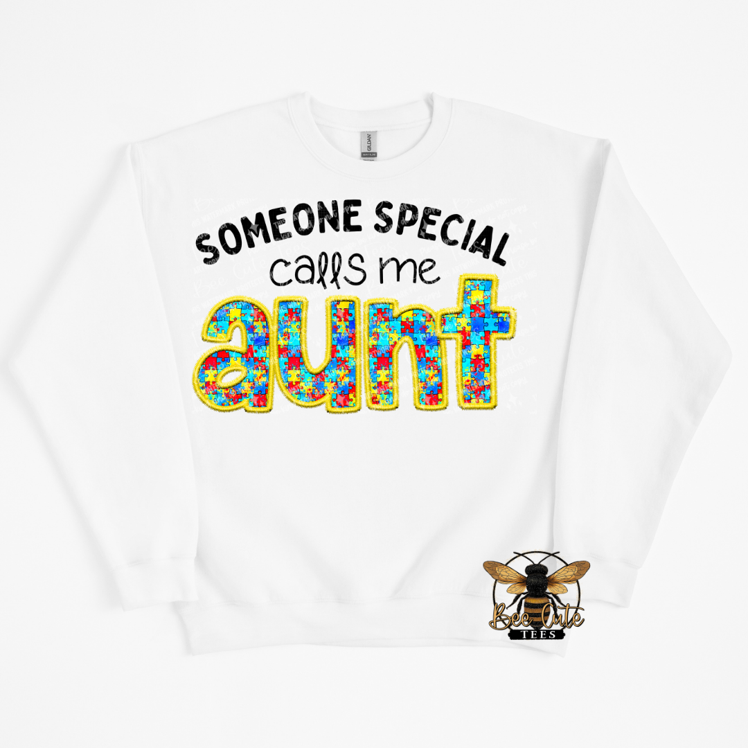 White sweatshirt with colorful text 'Someone special calls me aunt' and a bee logo on a white background