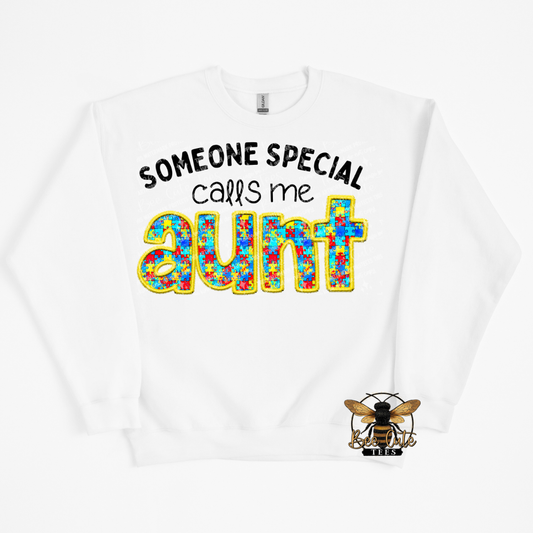 White sweatshirt with colorful text 'Someone special calls me aunt' and a bee logo on a white background