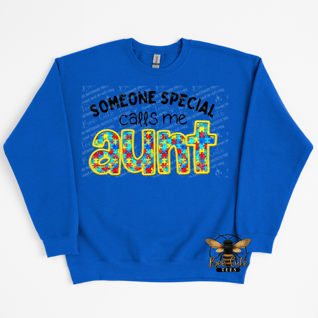 Blue sweatshirt with colorful text 'Someone special calls me aunt' on a white background