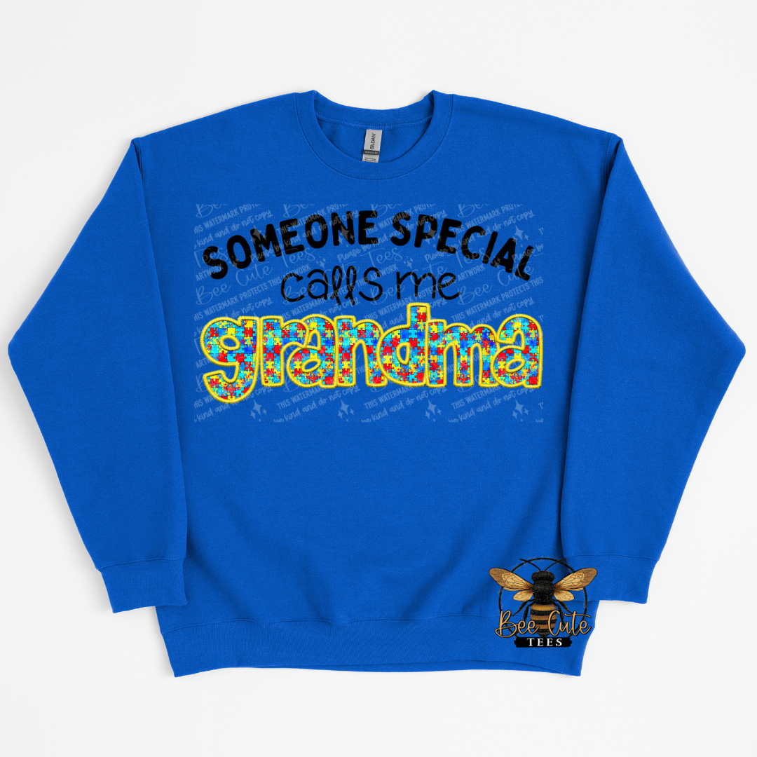 Blue sweatshirt with colorful text 'Someone special calls me Grandma' on a white background