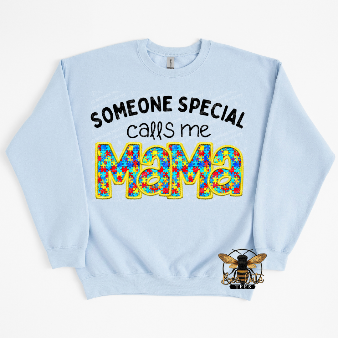 Light blue sweatshirt with colorful text 'Someone special calls me Mama' on a white background