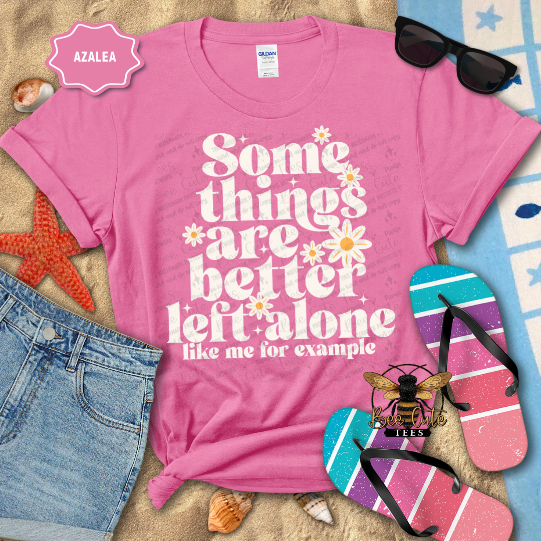 Pink t-shirt with humorous text design on a beach-themed background
