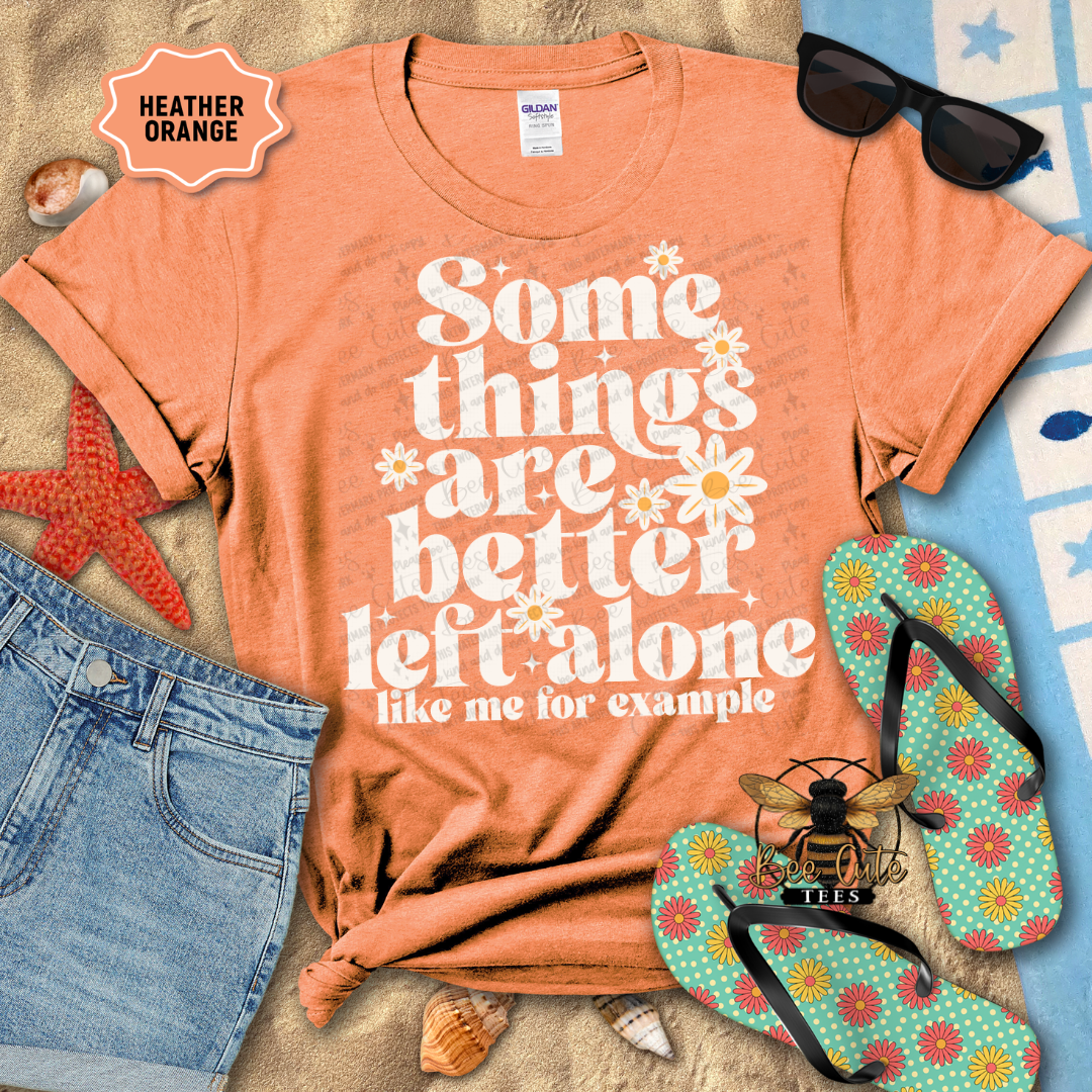 Orange t-shirt with humorous text, sunglasses, jeans, starfish, and flip-flops on a textured surface.