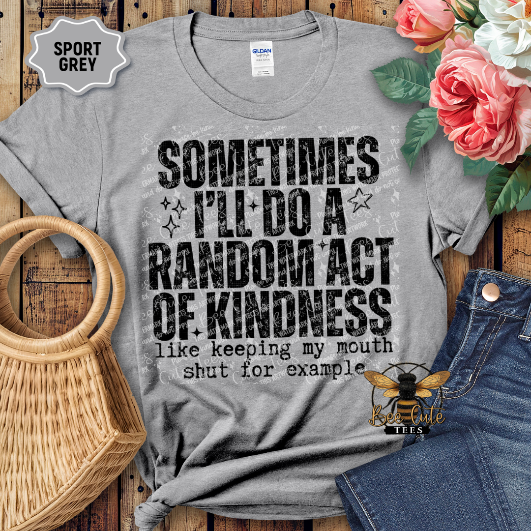 Gray t-shirt with humorous text design on a wooden surface with flowers and jeans.