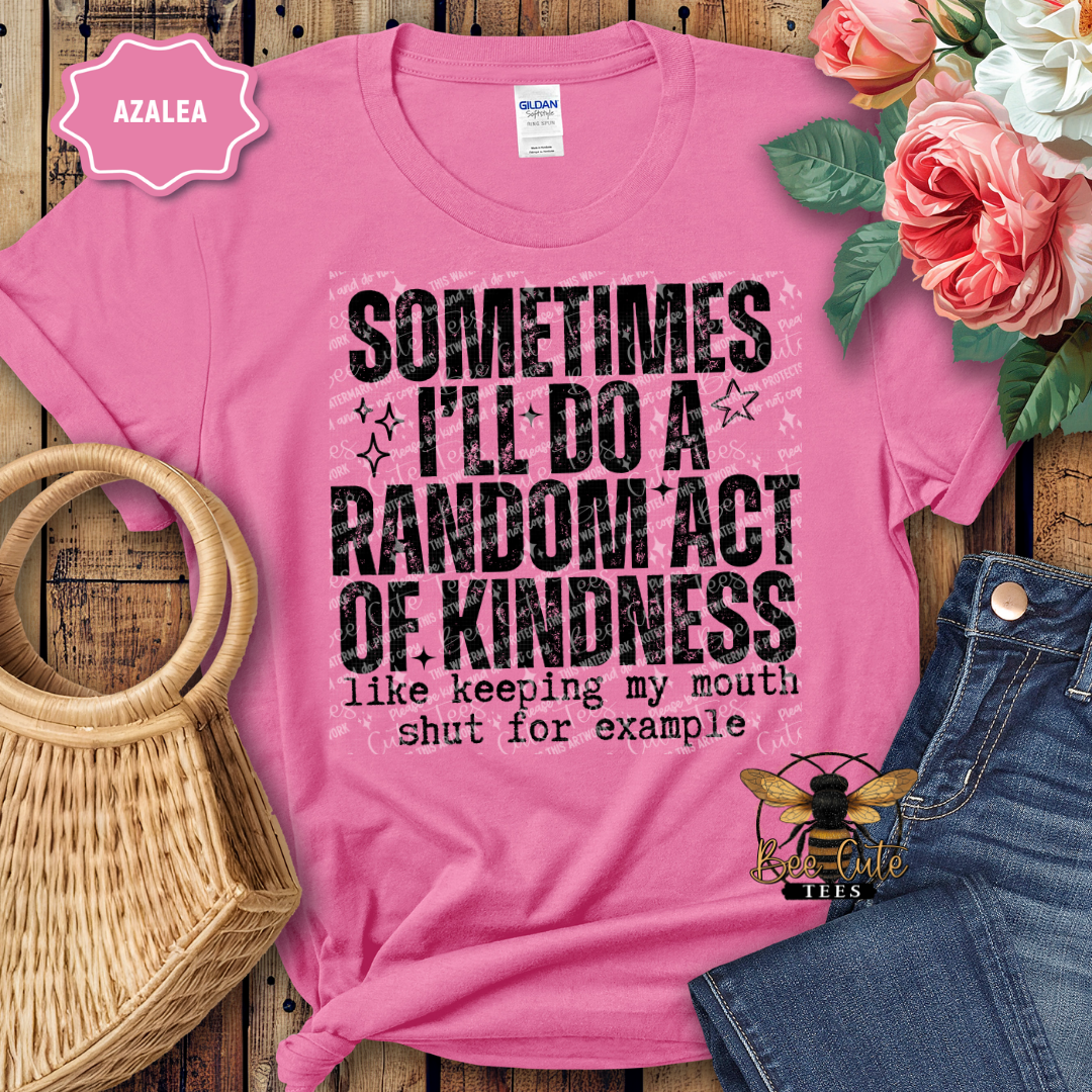 Pink t-shirt with motivational quote, surrounded by flowers and jeans on a wooden surface.