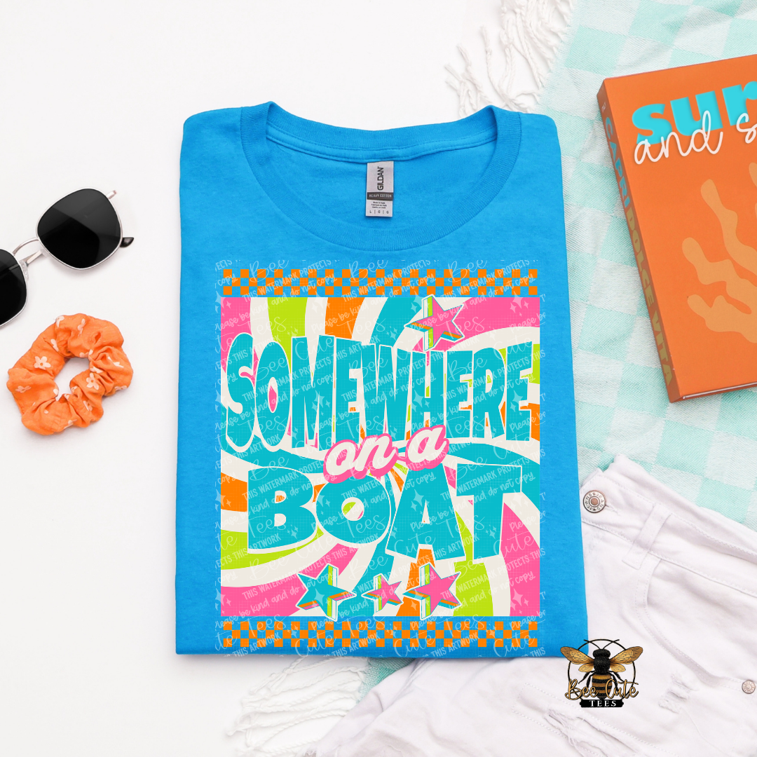Blue t-shirt with colorful 'Somewhere on a Boat' design on a light blue background