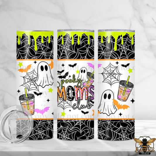 Three tall insulated tumblers with Halloween-themed wraparound designs are shown on a light marble surface. The design features black spiderwebs, white ghosts, orange bats, purple stars, and the text 'Spooky Moms club'.