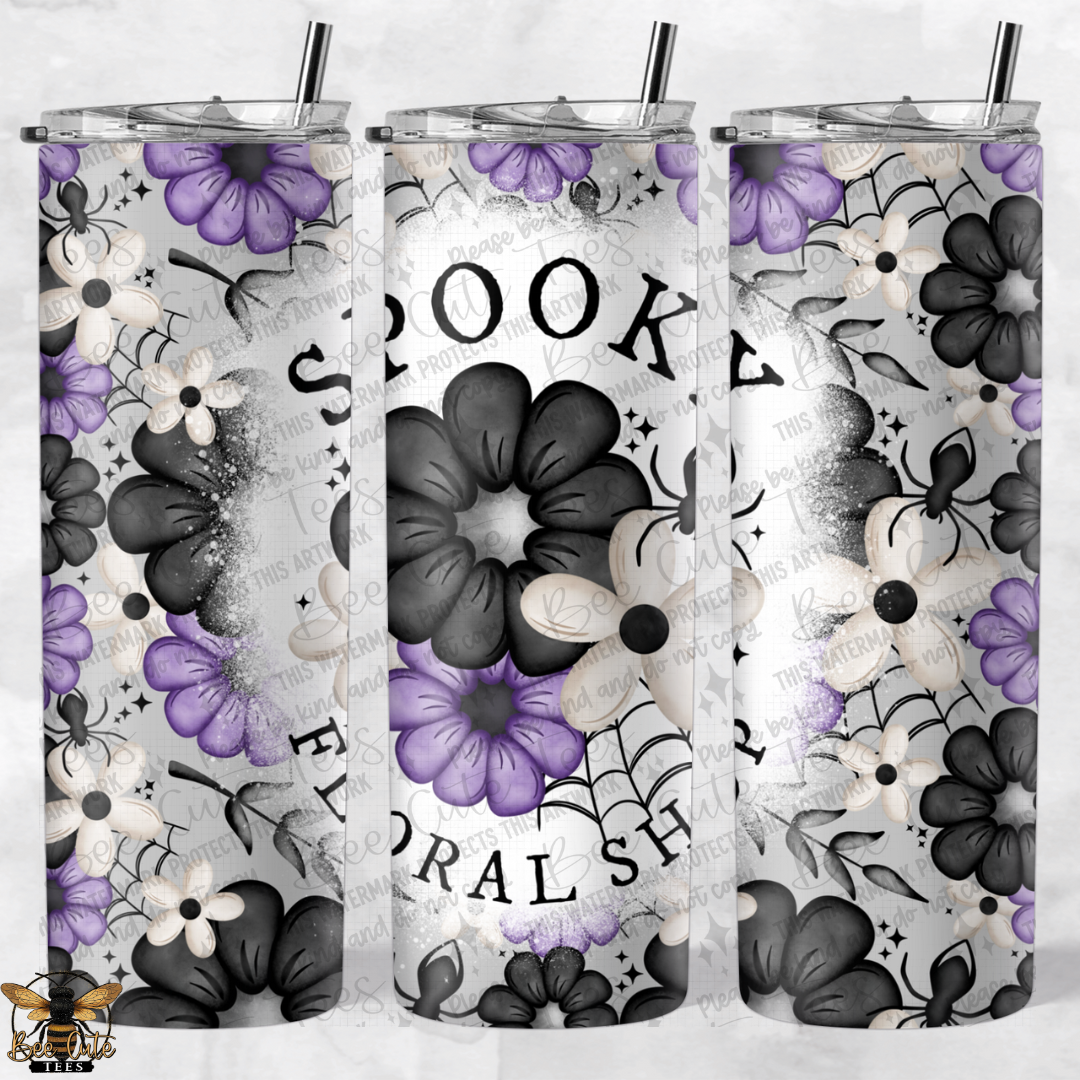 Three floral-themed tumblers with black and purple flowers on a gray background.