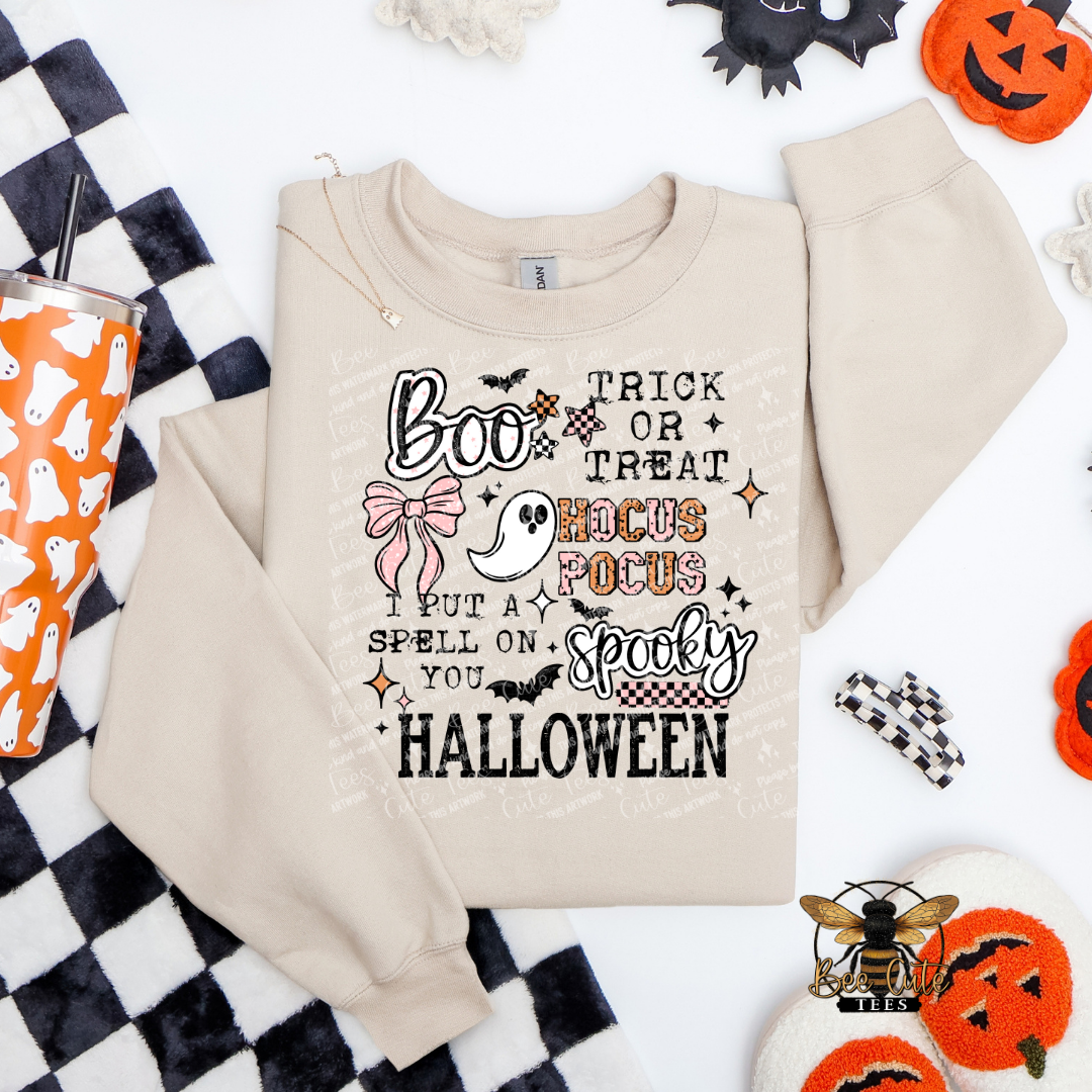 Beige sweatshirt with Halloween-themed text on a checkered fabric background