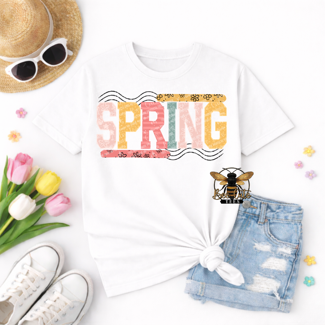 White t-shirt with 'SPRING' design, sunglasses, tulips, shorts, and sneakers on a white background