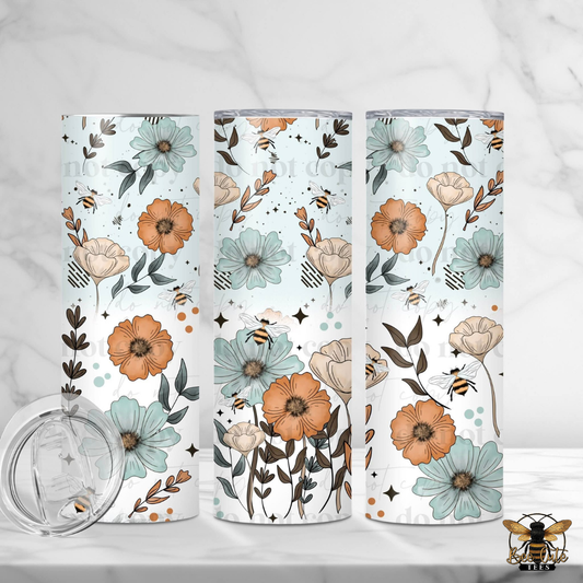 Three floral-patterned tumblers on a white background