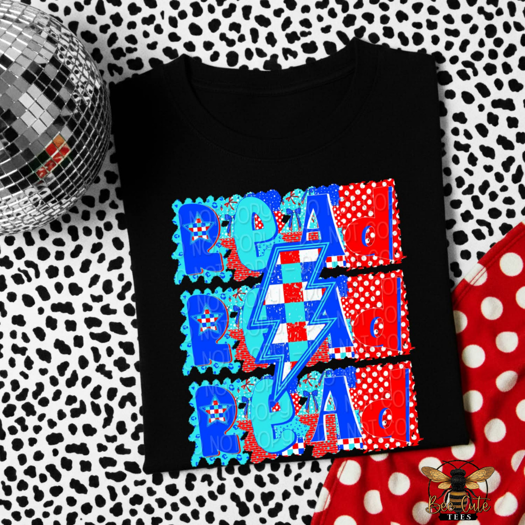 Black t-shirt with colorful graphic design on a patterned background