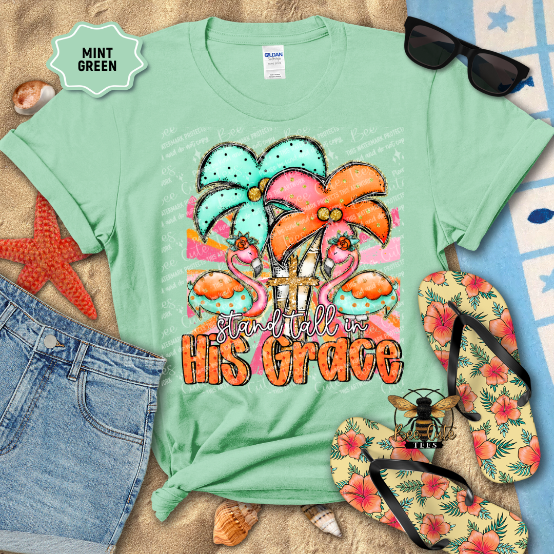 Mint green t-shirt with floral design and 'Stand Tall in His Grace' text, surrounded by beach accessories.