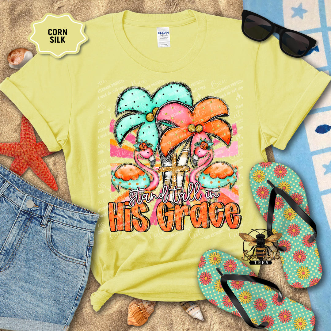 Yellow t-shirt with colorful design and text 'Stand Tall in His Grace' on a beach-themed background.